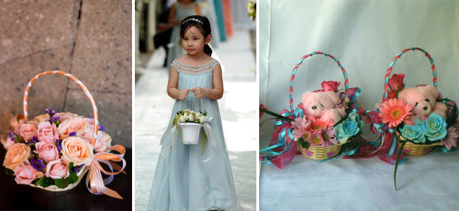 From left to right: Basket of flowers by AA Wedding Essentials Provider, A basket of white rose buds held by a flowergirl. Arrangement is by Henry Pascual Events Stylists and Flower baskets with bears as focal point by Julius and Carol Flower Shop